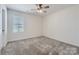 Bright bedroom features neutral walls, plush carpeting, ceiling fan, and window offering natural light at 428 Nixon Rd, Belmont, NC 28012