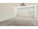 Spacious bedroom with plush carpeting, large windows, and a modern ceiling fan at 428 Nixon Rd, Belmont, NC 28012