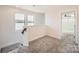 Upstairs hallway features neutral colored carpet and railing overlooking a view of the stairs at 428 Nixon Rd, Belmont, NC 28012