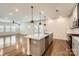 Modern kitchen features an island with a sink and dishwasher, stainless steel appliances, and wood floors at 428 Nixon Rd, Belmont, NC 28012
