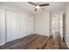 Bright bedroom with hardwood floors, a ceiling fan, and sliding closet doors at 433 W 8Th St, Charlotte, NC 28202