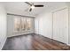 Well-lit bedroom with hardwood floors, a ceiling fan, and a large window at 433 W 8Th St, Charlotte, NC 28202