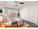 Bright bedroom offers hardwood floors, a ceiling fan, a large window, and double closet at 433 W 8Th St, Charlotte, NC 28202
