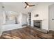 Bright living room featuring hardwood floors, a fireplace, and an open layout to the kitchen at 433 W 8Th St, Charlotte, NC 28202