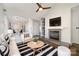 Bright living room features a fireplace, a ceiling fan, and a modern black and white striped rug at 433 W 8Th St, Charlotte, NC 28202