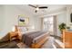 Neutral main bedroom with ceiling fan, hardwood floors, large windows, and ensuite bathroom at 433 W 8Th St, Charlotte, NC 28202