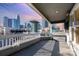 A covered patio with railing offers city views from this home's elevated deck at 433 W 8Th St, Charlotte, NC 28202