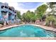 Community pool features lounge chairs, privacy fencing, and lush landscaping at 433 W 8Th St, Charlotte, NC 28202