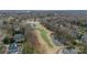 Aerial view of a golf course community featuring a scenic pond and lush landscaping at 4335 Piper Glen Dr, Charlotte, NC 28277