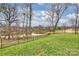 Picturesque backyard view of a pond, lush greenery, and surrounding neighborhood in a tranquil setting at 4335 Piper Glen Dr, Charlotte, NC 28277