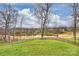 Serene backyard view overlooking a pond and golf course, creating a peaceful and scenic outdoor space at 4335 Piper Glen Dr, Charlotte, NC 28277