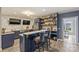 Basement bar area with seating, full shelving, stainless appliances and stylish finishes at 4335 Piper Glen Dr, Charlotte, NC 28277