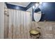 Bathroom with unique sink, gold fixtures, decorative mirror, and stylish shower curtain at 4335 Piper Glen Dr, Charlotte, NC 28277