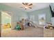 Bright bedroom with a house-shaped bunkbed that features a slide and stairs for easy access at 4335 Piper Glen Dr, Charlotte, NC 28277