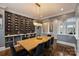 Dining room with hardwood floors, a modern chandelier, a wine rack, and neutral color palette at 4335 Piper Glen Dr, Charlotte, NC 28277