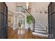 Elegant foyer with a curved staircase, iron railings, hardwood floors, and soaring ceilings at 4335 Piper Glen Dr, Charlotte, NC 28277