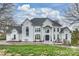 Elegant home featuring a symmetrical facade, arched windows, and a meticulously maintained front lawn at 4335 Piper Glen Dr, Charlotte, NC 28277