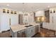 Spacious kitchen with a center island, stainless steel appliances, custom cabinetry, and pendant lighting at 4335 Piper Glen Dr, Charlotte, NC 28277