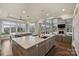 Gourmet kitchen with a large island, seating, pendant lights, and open view to the living room at 4335 Piper Glen Dr, Charlotte, NC 28277