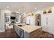 Open kitchen with a large island, stainless steel appliances, and seamless flow into the living area at 4335 Piper Glen Dr, Charlotte, NC 28277