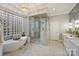 Elegant main bathroom features a soaking tub, glass shower, and marble countertops at 4335 Piper Glen Dr, Charlotte, NC 28277
