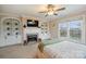 Large bedroom with built-in bookshelves around fireplace and a view of the water at 4335 Piper Glen Dr, Charlotte, NC 28277