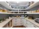 Well-organized pantry featuring custom shelving, marble countertops and modern cabinetry with gold hardware at 4335 Piper Glen Dr, Charlotte, NC 28277