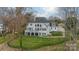 Spacious backyard with a large covered terrace and multiple windows, offering a blend of indoor-outdoor living at 4335 Piper Glen Dr, Charlotte, NC 28277