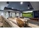 Home theater with tiered seating, projector screen, and surround sound at 4335 Piper Glen Dr, Charlotte, NC 28277