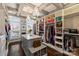 A beautiful walk-in closet with custom shelves, storage island, bench, natural light, and gorgeous chandeliers at 4335 Piper Glen Dr, Charlotte, NC 28277