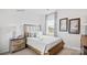 Comfortable bedroom with a soft bed, bedside table, and a window view of the outdoors at 469 Court House Ave, York, SC 29745