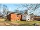 Backyard view of the house with a brick exterior at 4914 Ridgeley Dr, Charlotte, NC 28208