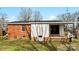 Backyard view of the house with a brick exterior at 4914 Ridgeley Dr, Charlotte, NC 28208