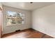 Empty bedroom featuring hardwood flooring, a window providing natural light and neutral wall color at 4914 Ridgeley Dr, Charlotte, NC 28208