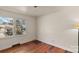 Bedroom with wood floors, window overlooking front yard, and overhead lighting at 4914 Ridgeley Dr, Charlotte, NC 28208