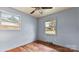 Bedroom with hardwood floors, a ceiling fan, and two windows at 4914 Ridgeley Dr, Charlotte, NC 28208