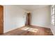 Empty bedroom featuring hardwood flooring, a window providing natural light and neutral wall color at 4914 Ridgeley Dr, Charlotte, NC 28208