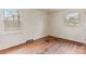 Empty bedroom featuring hardwood flooring, two windows providing natural light and neutral wall color at 4914 Ridgeley Dr, Charlotte, NC 28208