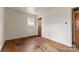Empty bedroom featuring hardwood flooring, a window providing natural light and neutral wall color at 4914 Ridgeley Dr, Charlotte, NC 28208