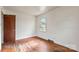 Empty bedroom featuring hardwood flooring, a window providing natural light and neutral wall color at 4914 Ridgeley Dr, Charlotte, NC 28208