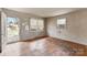 Living room with hardwood floors and two windows at 4914 Ridgeley Dr, Charlotte, NC 28208