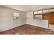 Living room with hardwood floors, window, and access to other rooms at 4914 Ridgeley Dr, Charlotte, NC 28208
