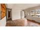 Living room with hardwood floors, large window, and a white door at 4914 Ridgeley Dr, Charlotte, NC 28208