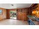 A room featuring wood walls, an open design, and sliding glass door to the outdoors at 4914 Ridgeley Dr, Charlotte, NC 28208