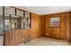 A room with an open design, featuring wood walls, and a window to the outdoors at 4914 Ridgeley Dr, Charlotte, NC 28208