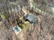 Private wooded lot featuring an in-ground pool and a winding driveway leading to the residence at 501 Colonels Ct, Clover, SC 29710