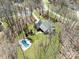 Beautiful aerial view of home surrounded by trees, with a pool and well-manicured lawn at 501 Colonels Ct, Clover, SC 29710