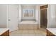 Bathroom with a soaking tub, tiled surround, and a separate glass-enclosed shower at 501 Colonels Ct, Clover, SC 29710