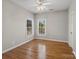 This bedroom has neutral walls, two windows, hardwood floors and a ceiling fan with light at 501 Colonels Ct, Clover, SC 29710