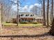 Well-maintained brick home with a welcoming front porch and mature trees surrounding the property at 501 Colonels Ct, Clover, SC 29710